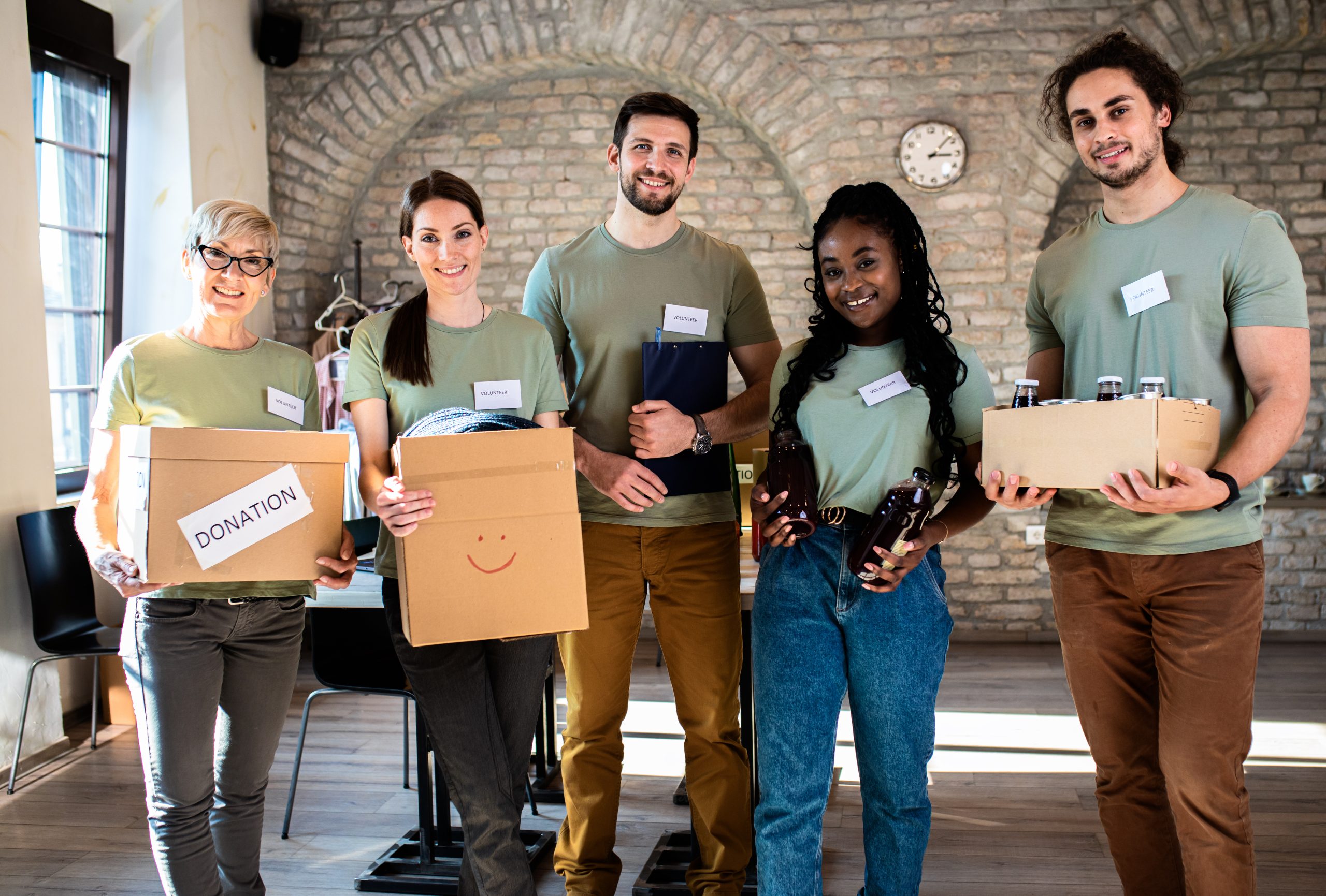 Portrait of volunteers with working in community charity donations